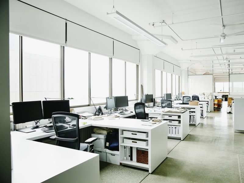 A large office with many desks and computers.